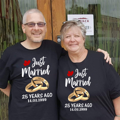 Two people wearing black t-shirts celebrating 25 years of marriage, standing in front of a wooden door.